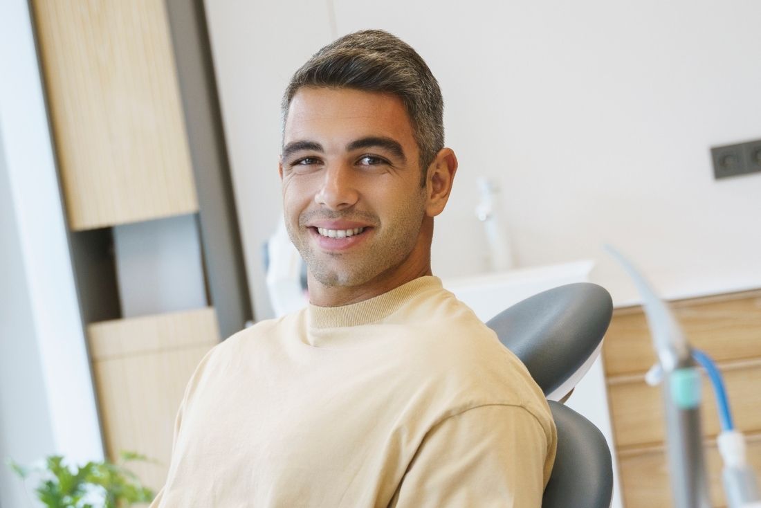 Man smiling in the dental chair at an All-on-4 dental implant consultation in Pompano Beach, FL